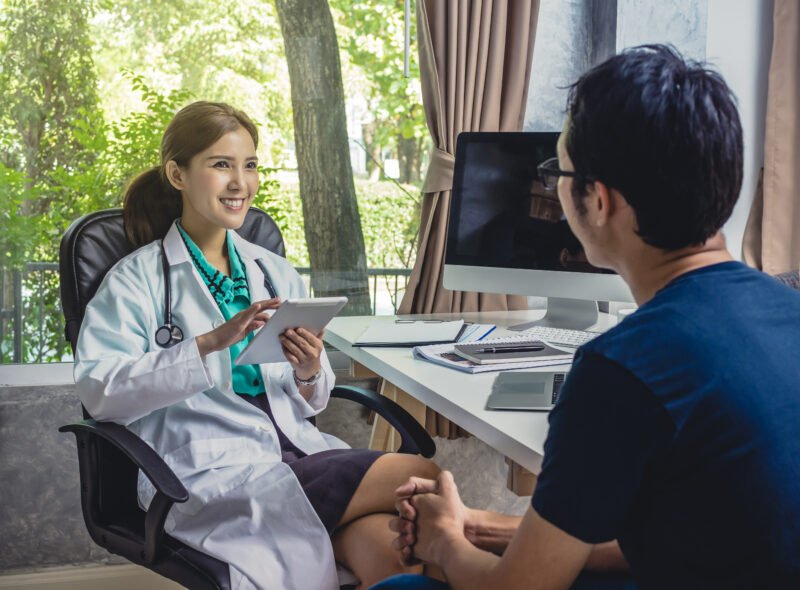 Asian Young doctor discussing diagnosis with patient about his