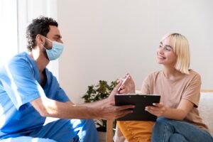 close up person talking with doctor about vaccination