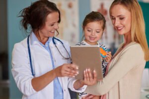 cute toddler with her mother doctor