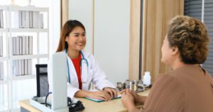 doctor discussing with patient while sitting medical clinic