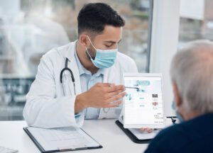 doctor man tablet with mask office healthcare information consulting clinic with patient professional male person medical advice technology hospital virus protection