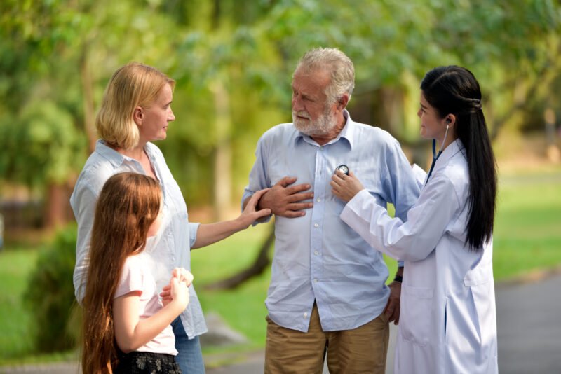 Female doctor and her elderly patient family outdoor. Female doctor and her elderly patient family outdoor.