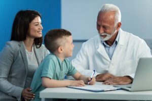 happy little boy his mother communicating with mature pediatrician appointment doctor s office