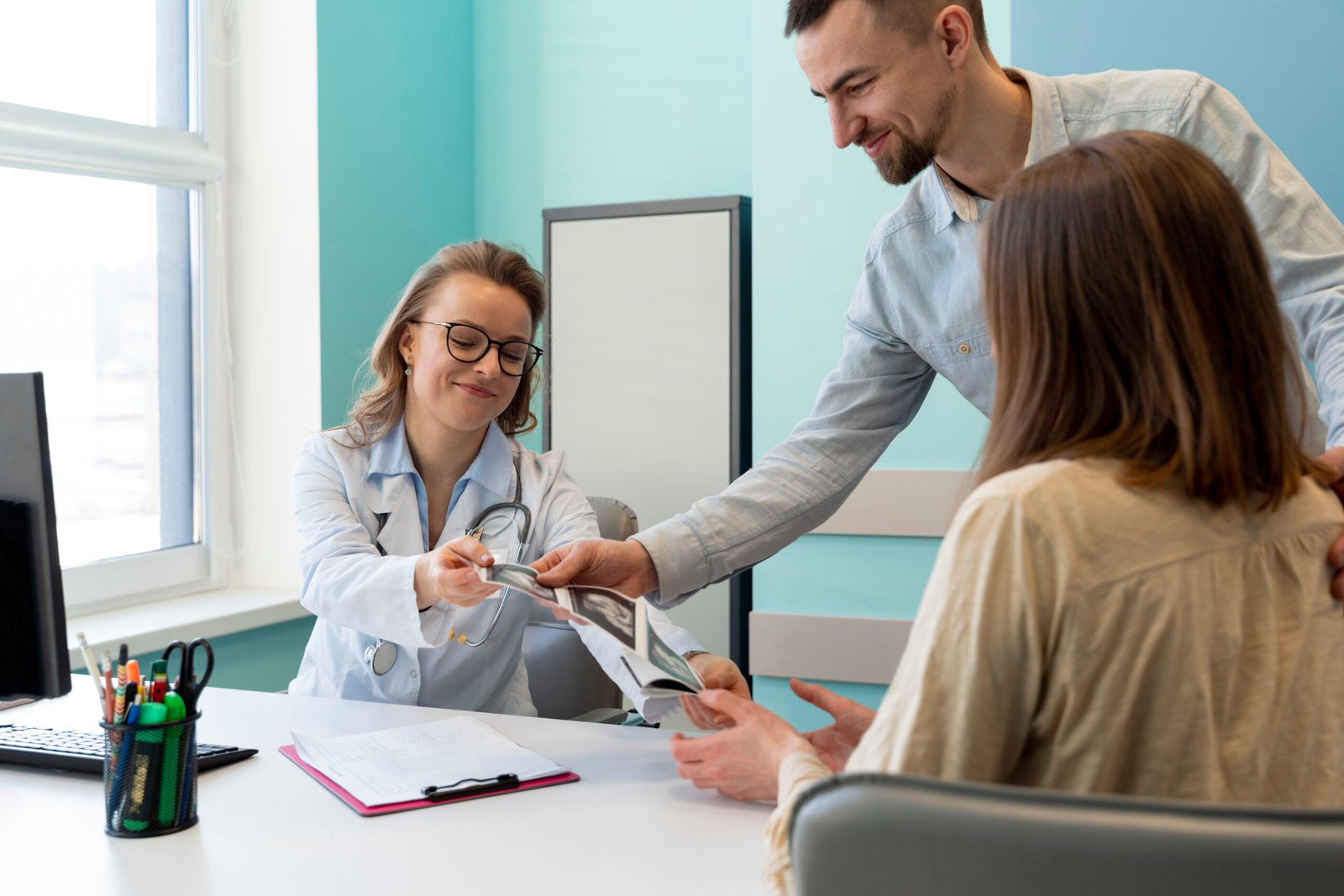 gynecologist evaluating pregnancy with patient 2 scaled